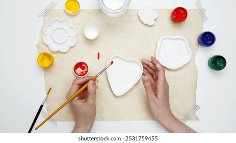 Hobby clay modeling. Woman paints clay products - Powered by Shutterstock