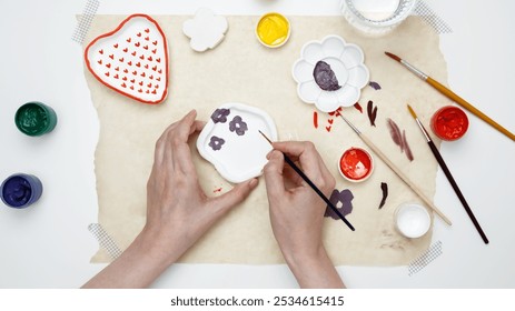 Hobby clay modeling. Woman paints clay products.  - Powered by Shutterstock