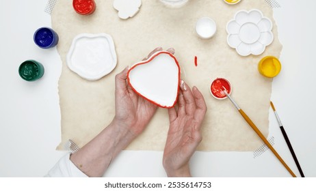 Hobby clay modeling. A woman paints clay products - Powered by Shutterstock