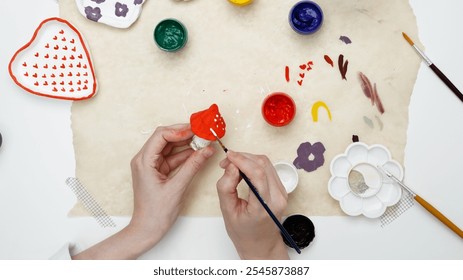 Hobby clay modeling. A woman paints clay products - Powered by Shutterstock