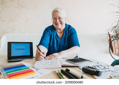 Hobby Ideas for Older People. Retirement Hobbies, Pastimes for Seniors. Activities for Seniors with Limited Mobility. Mature, elderly Senior Female Artist practices calligraphy and hand lettering