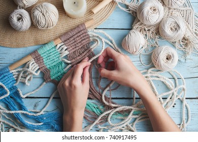 Hobby knitting macrame top view of the hand and thread on a wooden Board - Shutterstock ID 740917495