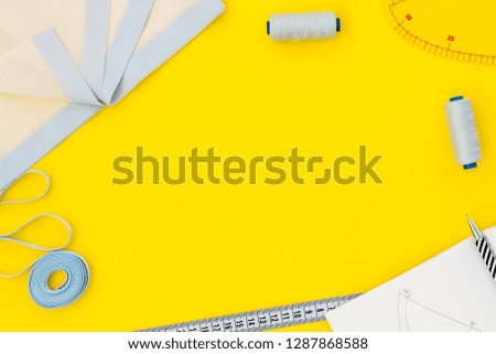 Hobby sewing with thread, fabric. Lifestyle. Yellow background top view mock up