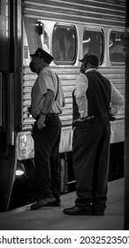 Hoboken, New Jersey - May 2021: New Jersey Transit Conductors Conversing While Gladstone Train Is On Layover.