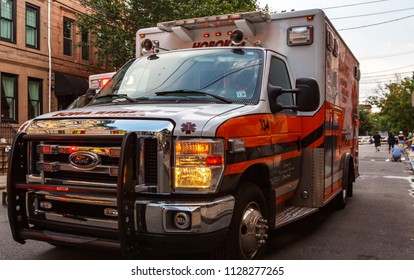 Hoboken, New Jersey / USA - 06 26 2018: EMS Ambulance Car Stay On Street In Daytime, Townhouses Around. 