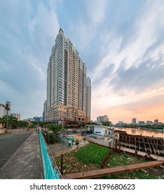 HOCHIMINH CITY, VIETNAM - JANUARY 19, 2022: Blue Hour In District 4, Novaland Residential Building Lights Up In The Late Afternoon, With A Beautiful Sunset Sky. The Car Runs Forming A Long Line Of Lig