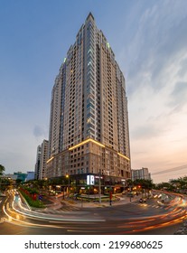 HOCHIMINH CITY, VIETNAM - JANUARY 19, 2022: Blue Hour In District 4, Novaland Residential Building Lights Up In The Late Afternoon, With A Beautiful Sunset Sky. The Car Runs Forming A Long Line Of Lig