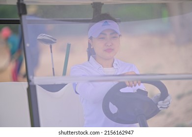 Hochiminh city, Vietnam - November 20th 2021: beautiful girl driving a tram in the golf course