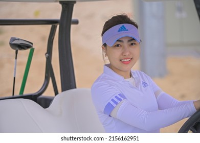 Hochiminh city, Vietnam - November 20th 2021: beautiful girl driving a tram in the golf course