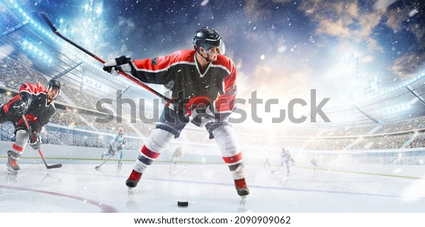 Hockey. Athlete in action. Professional hockey\
athlete swinging his stick. Hockey player in helmet and gloves at\
the winter stadium. Sports\
emotions