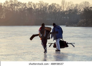 Hockey Go Away After A Hockey Game. Hockey Players Go On The Frozen River After A Game Of Hockey Outdoor.Winter Playing, Fun, Snow.  