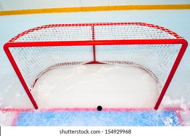 Hockey Goal With Puck On Red Line. View From Above