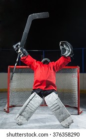 Hockey Goalkeeper Standing Elated With Arms Raised Up Above Her Head