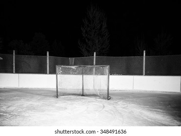 A Hockey Net On An Outdoor Ice Skating Rink In Black And White