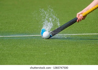 hockey player with ball in attack playing field hockey game
