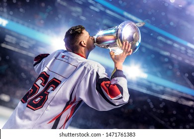 Hockey Player Celebrate Goal. Hold Cup In Hand Around Ice Rink Arena