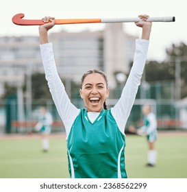 Hockey player in portrait, woman on turf with celebration and smile for fitness and sports win during game. Cheers, happiness and young athlete with stick, success and champion in competition - Powered by Shutterstock