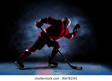 Hockey Player In Red Uniform Run Across Ice Rink. Over Dark Background