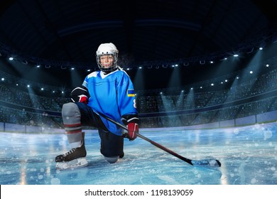 Hockey Player With Stick Standing On One Knee