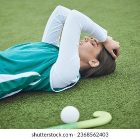 Hockey player, woman is tired in field with fitness and sport, challenge or loss with burnout outdoor. Exercise, wellness and fatigue with fail in competition, mistake and crisis on stadium turf - Powered by Shutterstock