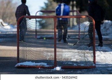 Hockey players playing street hockey in winter