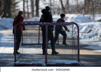 Hockey Players Playing Street Hockey In Winter