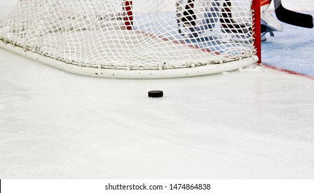 Hockey Puck Behind The Hockey Net