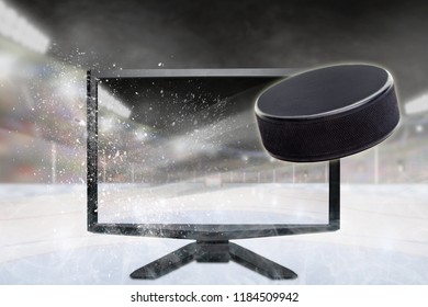 Hockey Puck Flying Out Of Shattering TV Screen In Stadium With Copy Space. Concept Of Realistic 3D Or 4D Sports TV, Virtual Reality VR Or Computer Gaming.