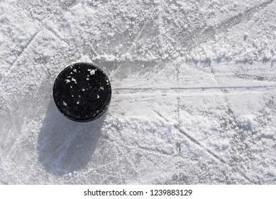 hockey puck lies on ice during the day