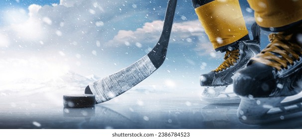 Hockey puck and stick close-up. Hockey player in ice rink. Focus on the puck. Hockey concept. Ice. Outdoor skating rink