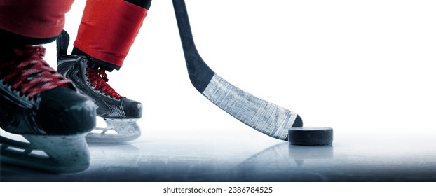 Hockey puck and stick close-up. Hockey player in ice rink. Focus on the puck. Hockey concept. Ice. Isolated