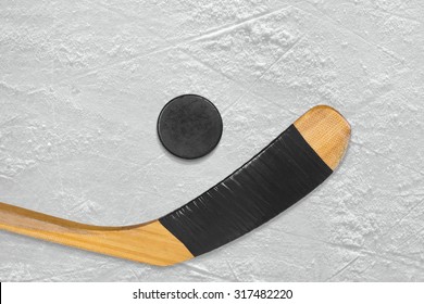 Hockey puck and stick on the ice arena. Texture, background