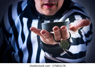 Hockey referee hold a puck in his palm. Close view