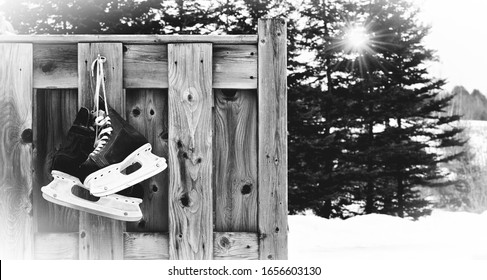 Hockey Skates Hanging On Outdoor Wooden Planks