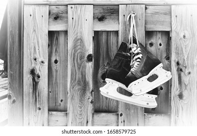 Hockey Skates Hanging On Outdoor Wooden Planks