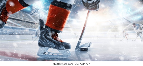 Hockey skates, stick and puck close-up. Hockey player in ice arena. Focus on the puck. Hockey player in action. Ice. Hockey stadium