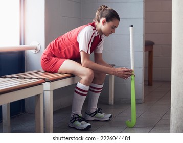 Hockey, sports and defeat with a woman athlete on a bench in the locker room after a competitive game loss. Fitness, exercise and sad with a female hockey player in the changing room of a sport club - Powered by Shutterstock