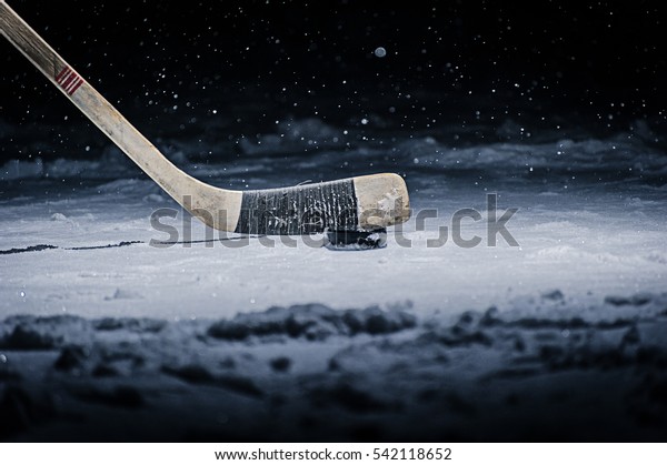 Hockey Stick and Puck on\
the Ice Rink