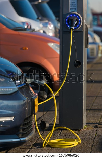 Hoek van Holland, the Netherlands - January\
20 2019: electric car charging batteries at plug in charge station\
in the Netherlands