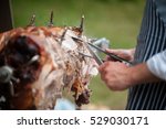 hog roast being carved for serving close up side view