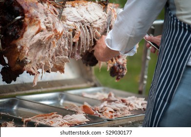 hog roast being carved for serving