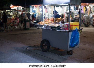 Hoi An, Vietnam - December 5 2019: Vendor with street food in Hoi An, at night, middle Vietnam