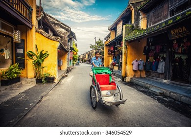 HOI AN, VIETNAM - November 14: Local Vietnam Man Riding A Traditional Cycle In  Hoi An On Apirl 14, 2014. Hoi An, A UNESCO World Heritage Site, Is A Major Touristic Destination In Central Vietnam.