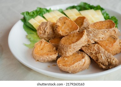 Hoi Jo (Deep Fried Crab Meat Roll), Close Up To Crab Meat In Tofu Wrap With Green Lettuce And Pineapple Pieces On White Plate.