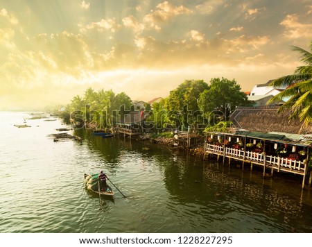 Hoi An traditional fisherman at sunset. Wooden fishing boats on the Thu Bon River in Hoi An Ancient Town (Hoian), Vietnam.
