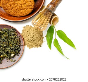 Hojicha green tea, cookies and chasen on white background, closeup - Shutterstock ID 2078262022