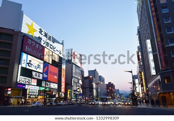 Hokkaido\
Japan March, 5 2019 : building and LED advertising  banner on\
Tanukikoji walking street in Supporo at\
sunset