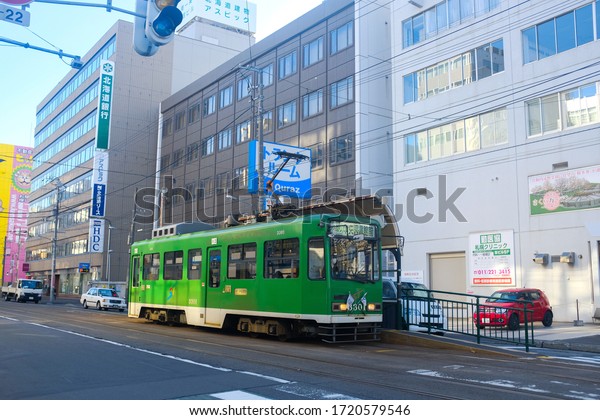 Hokkaido, Japan - October\
29, 2019 : View of a Sapporo streetcar (shiden) on the road during\
autumn at Sapporo. It is a tram network operated by the City\
Transportation Bureau