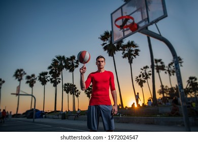 Hold Basketball Ball On Venice Beach Basketball Court. Hand Spinning Basket Ball. Balancing Basketball On Finger.