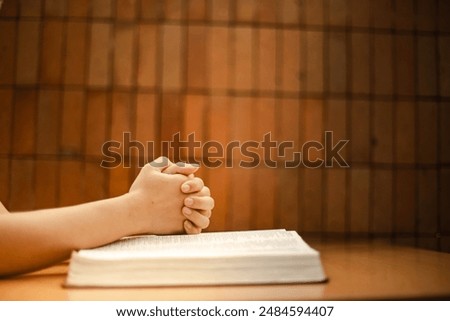 Hold hands while praying about the Bible in a quiet space. Solitary talk with God